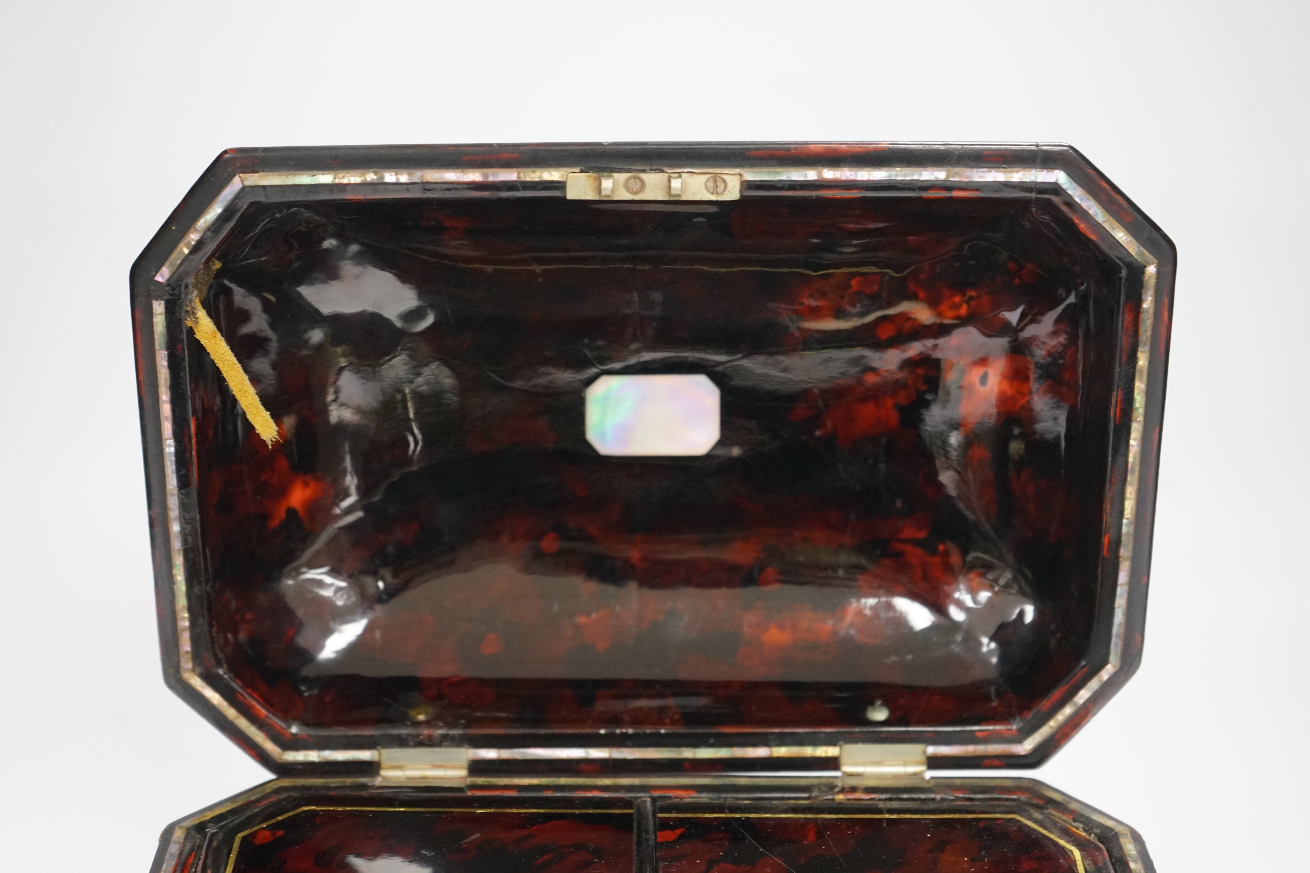 A Victorian papier mache tea caddy, stamped Jennens and Bettridge, in the form of a sarcophagus with inset mother of pearl banding, with two internal lidded compartments, 15cm high